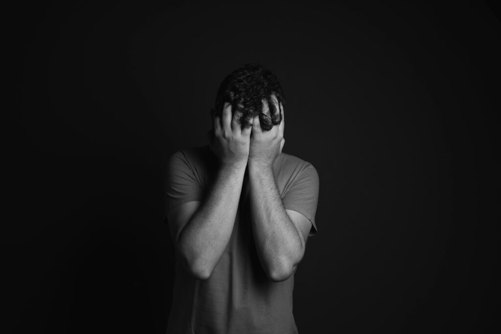 A person keeping his both the hands on his head showcasing depression